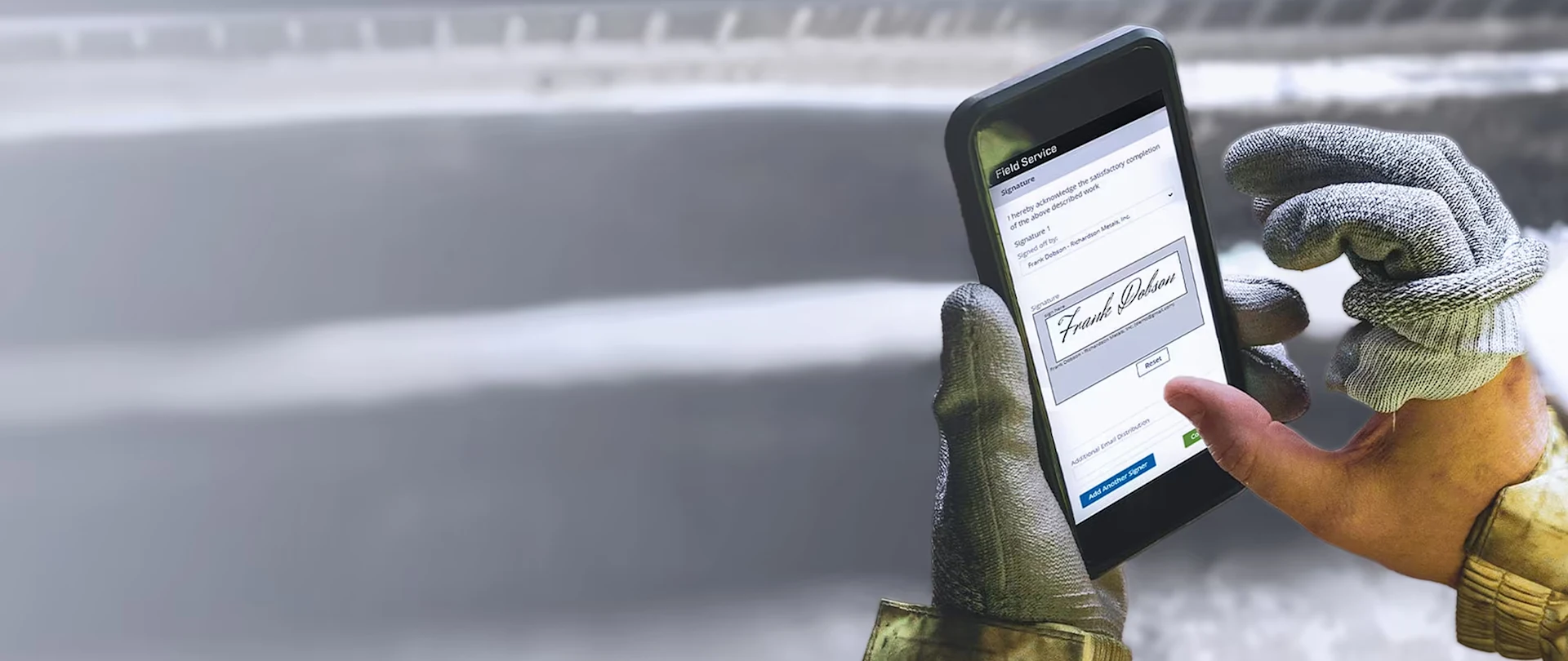 A technician wearing heavy-duty gloves uses the Trimble Vista Field Service app to capture a digital signature for work at Richardson Metals, Inc.
