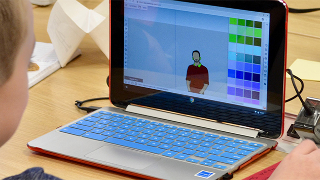 Child using Trimble SketchUp on laptop in classroom