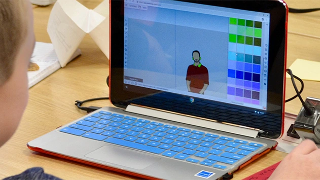 Child using Trimble SketchUp on laptop in classroom