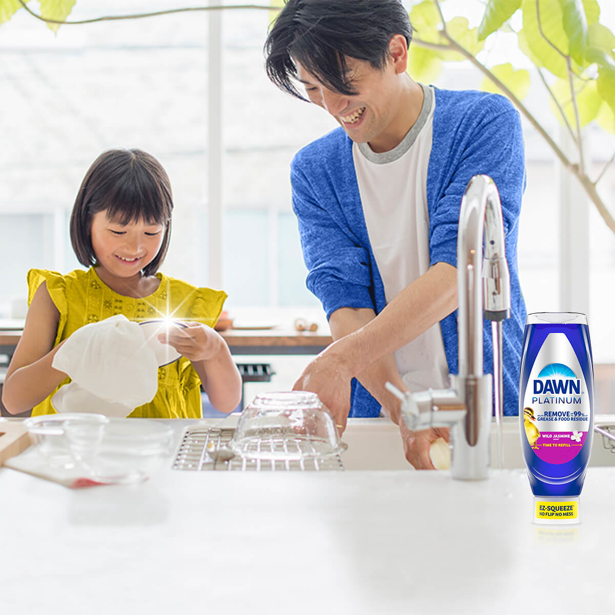 Dad and daughter cleaning dishes with Dawn Wild Jasmine