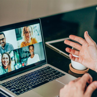 A person on a video call on their laptop with four people