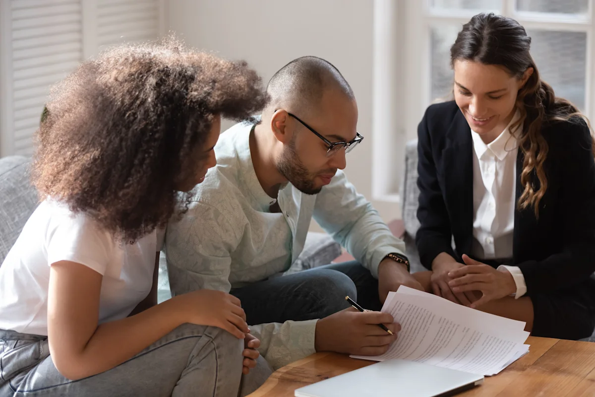 couple doing paperwork with lawyer