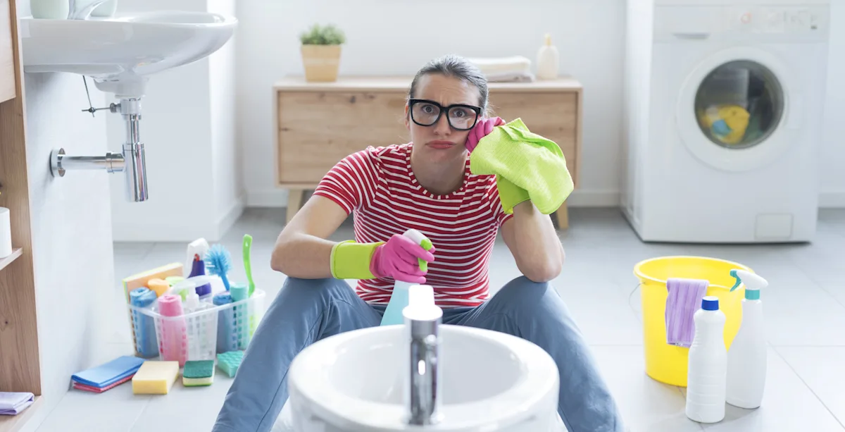 woman sitting with cleaning supplies