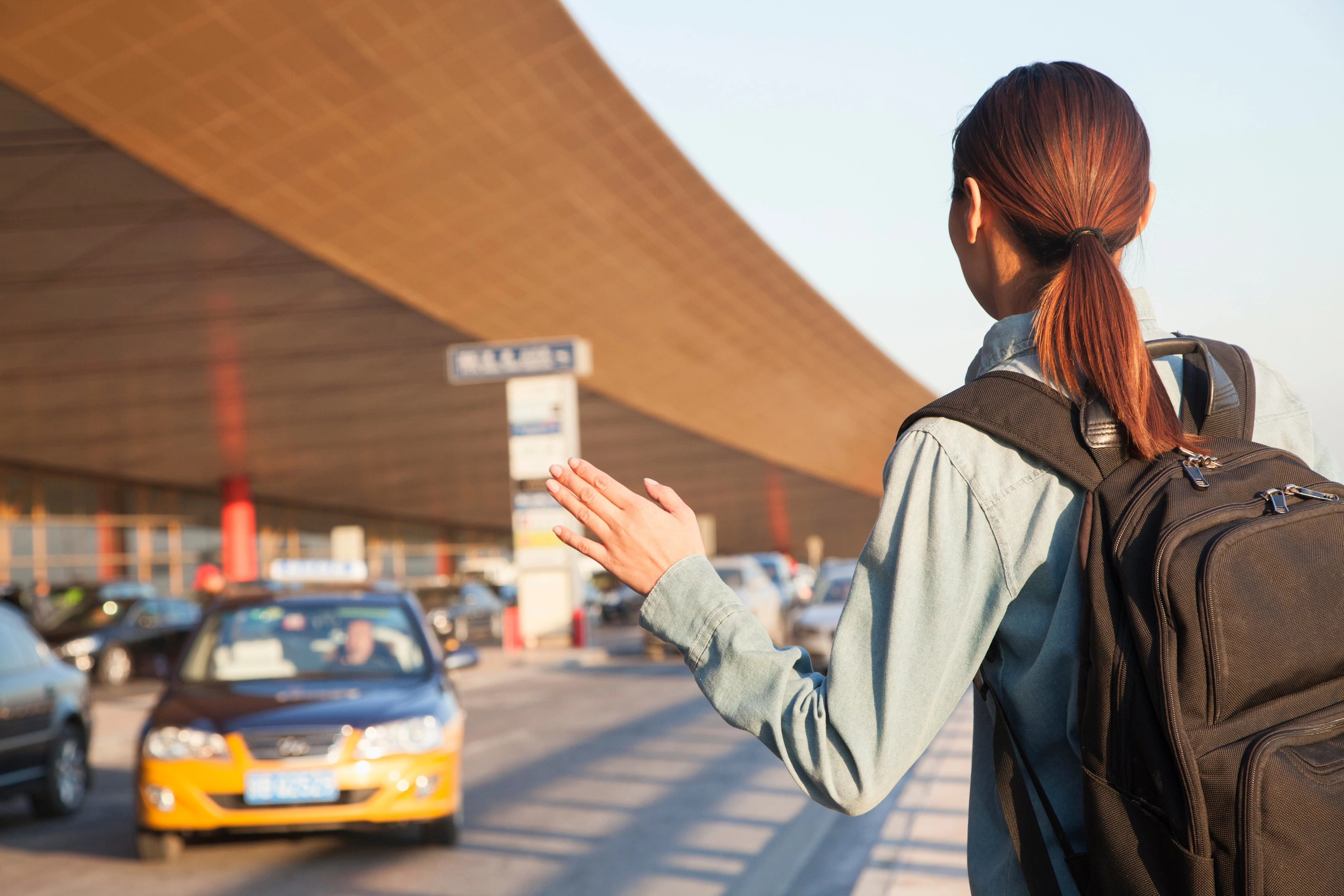 Woman catching airport taxi