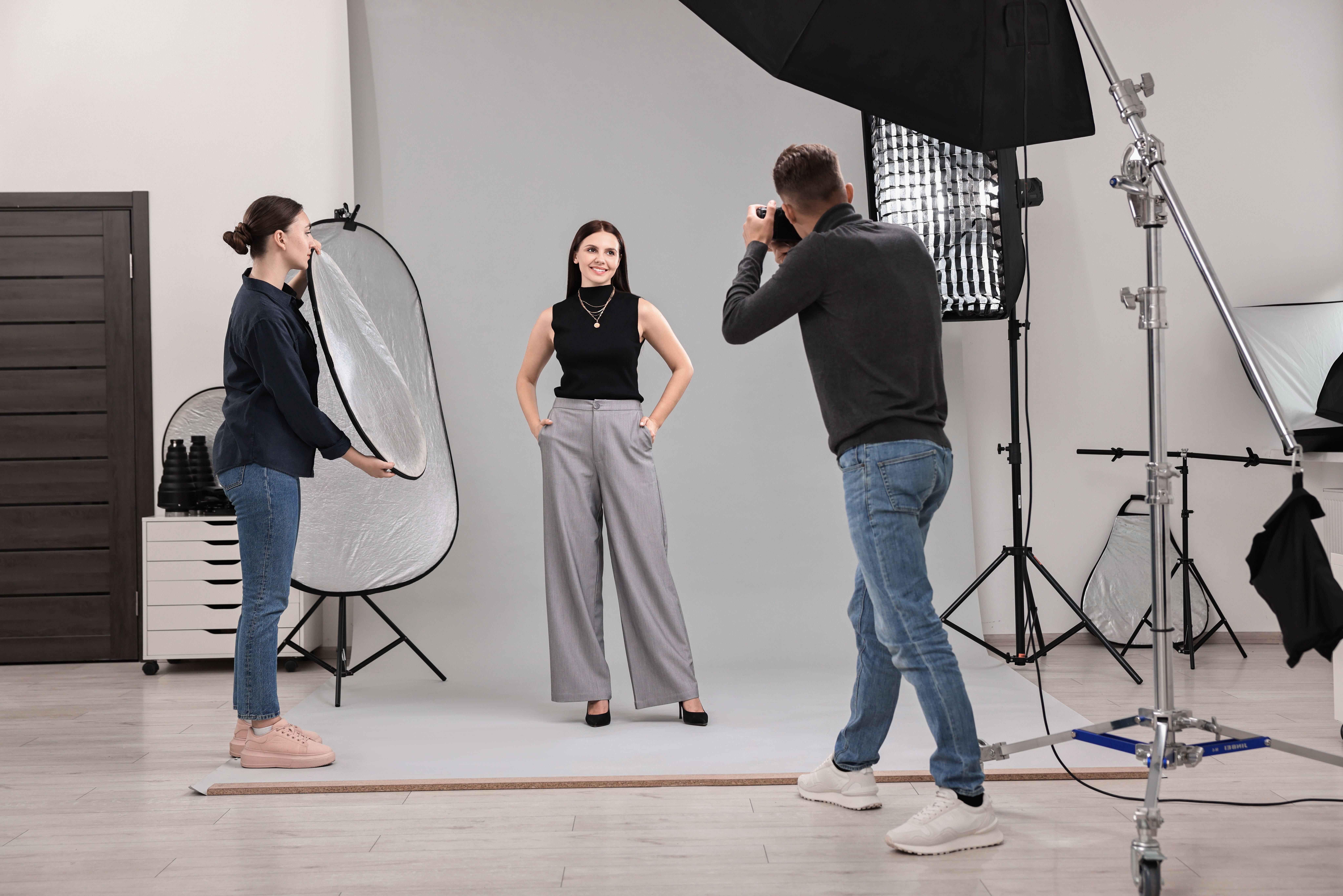 Photographer in studio with client for shoot