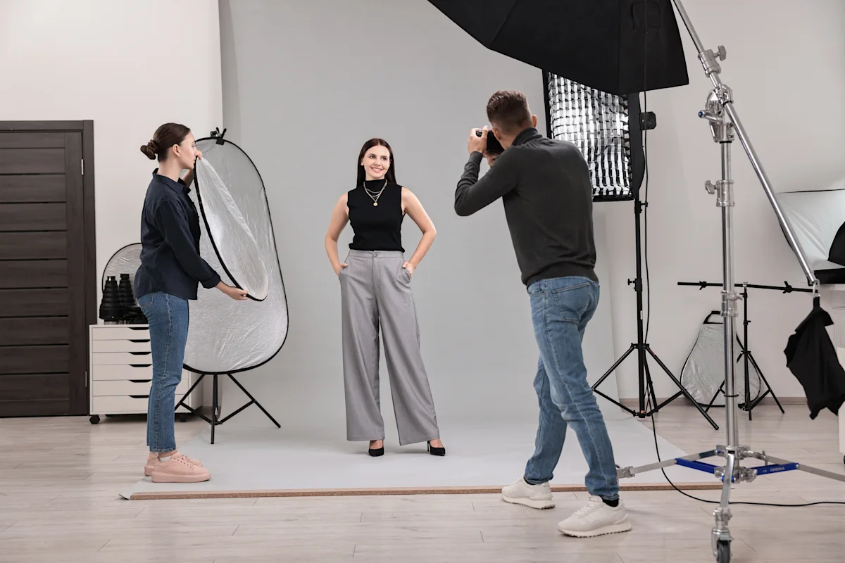 Photographer in studio with client for shoot
