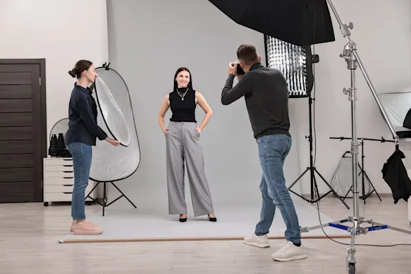 Photographer in studio with client for shoot