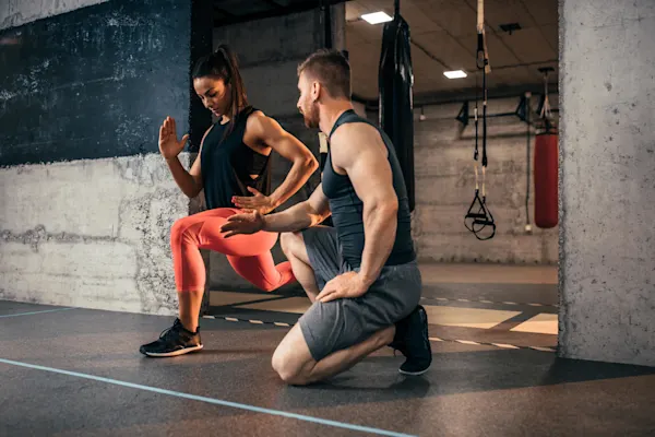 Personal trainer coaching a woman