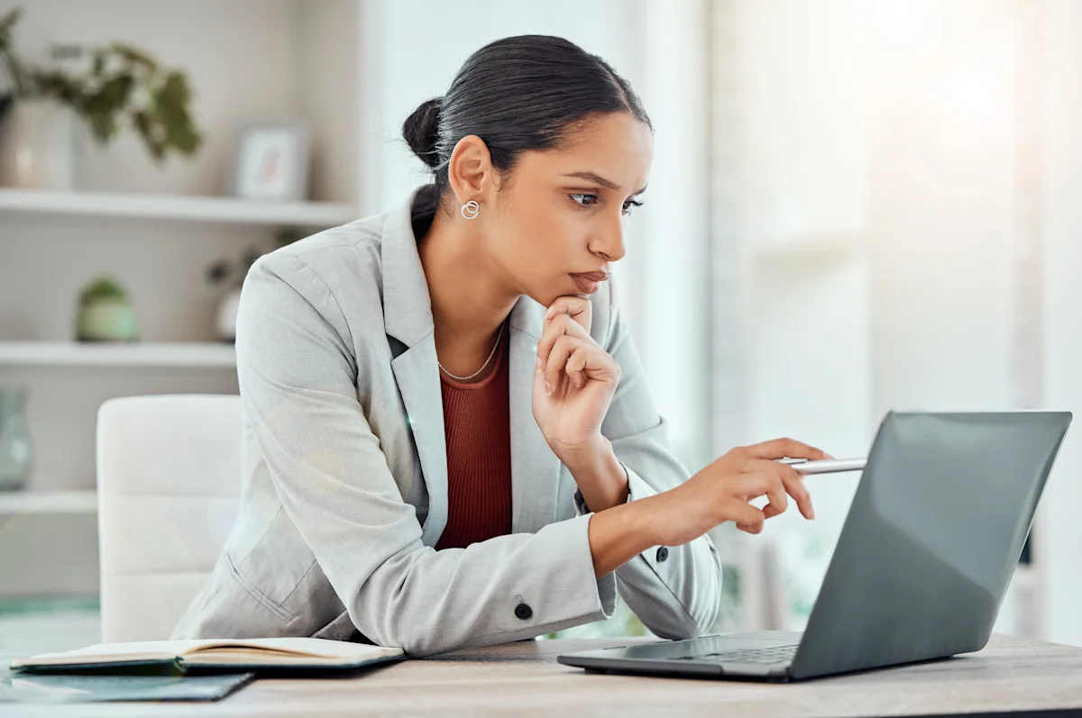 woman looking intently at laptop