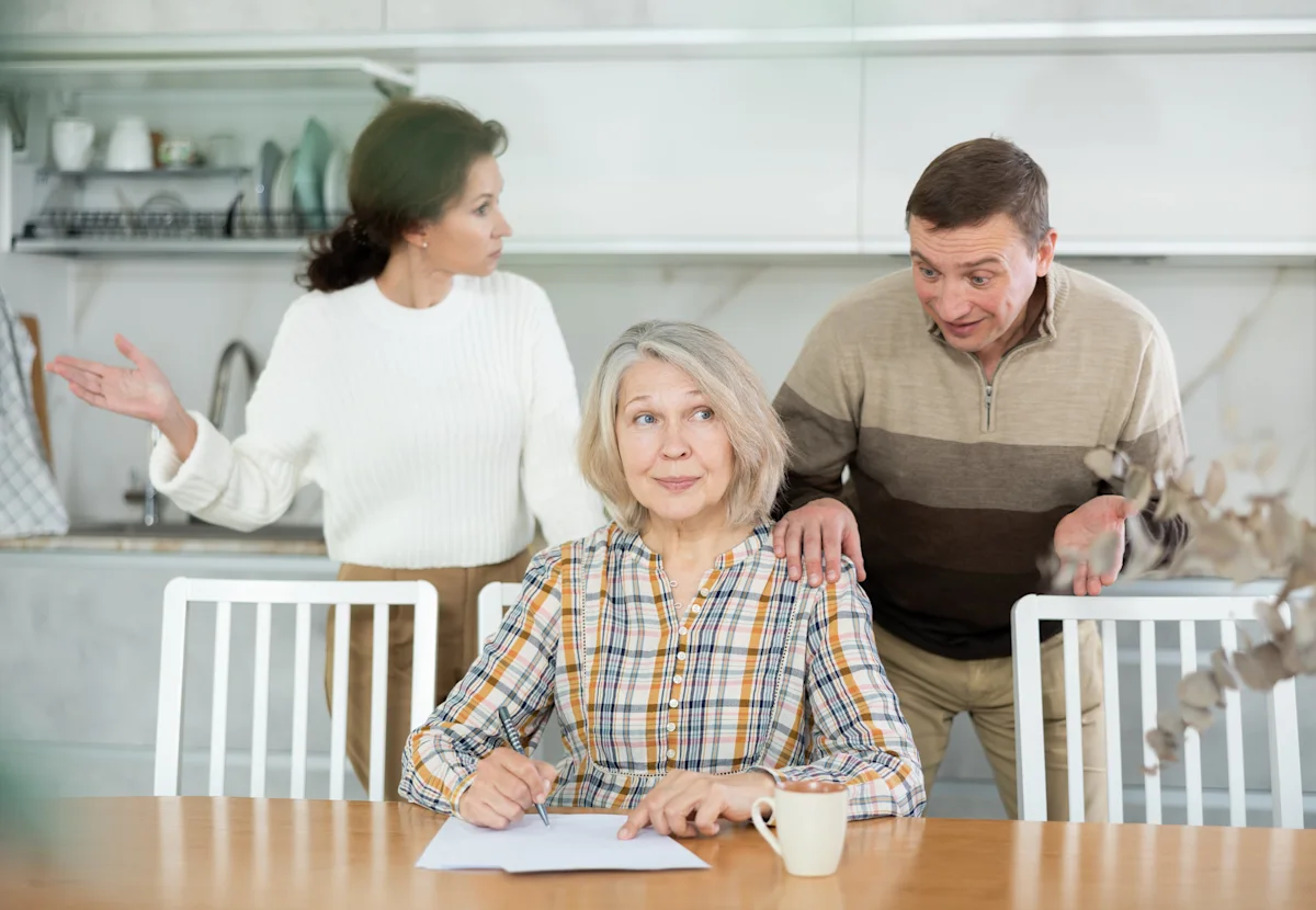 senior woman signing inheritance papers