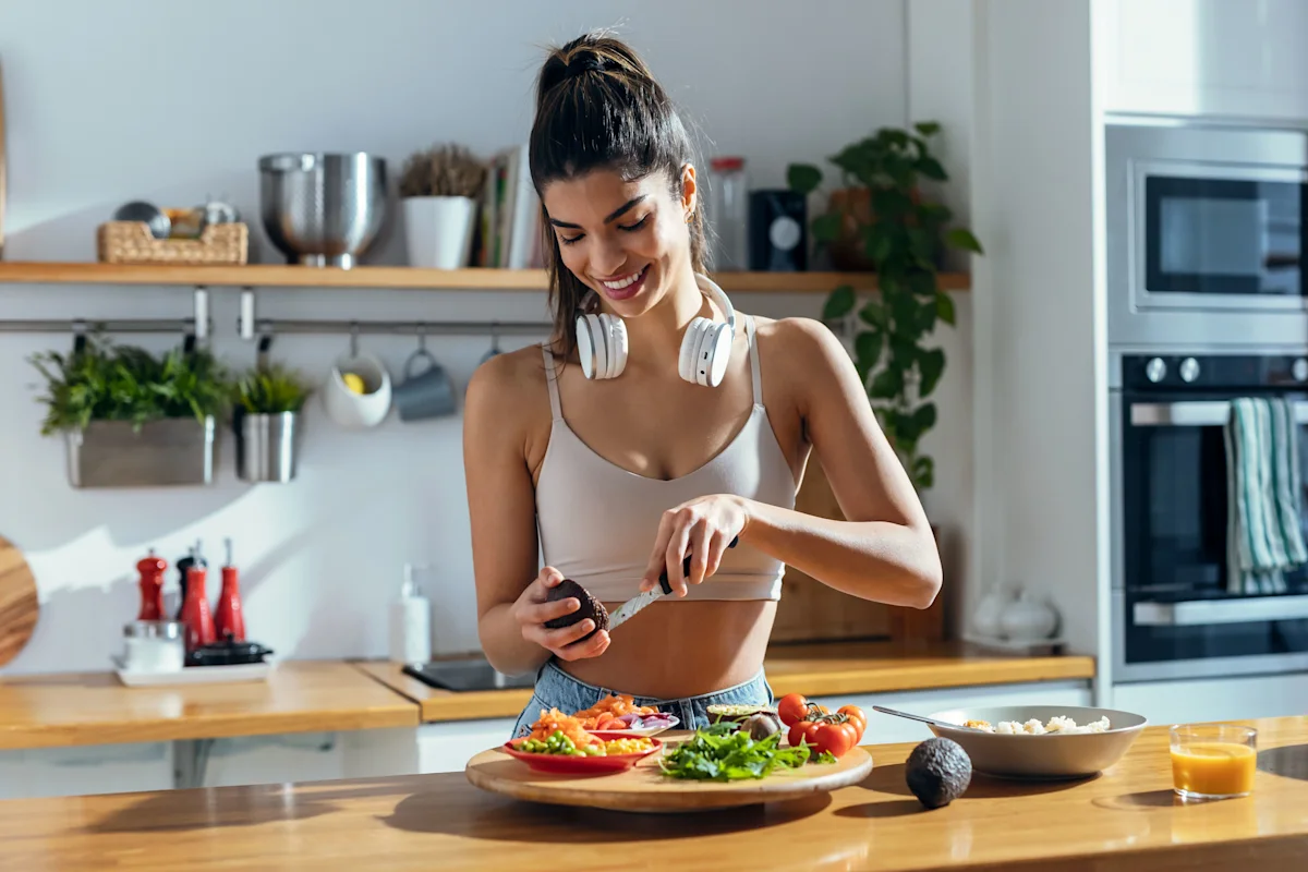 happy fit woman making a salad