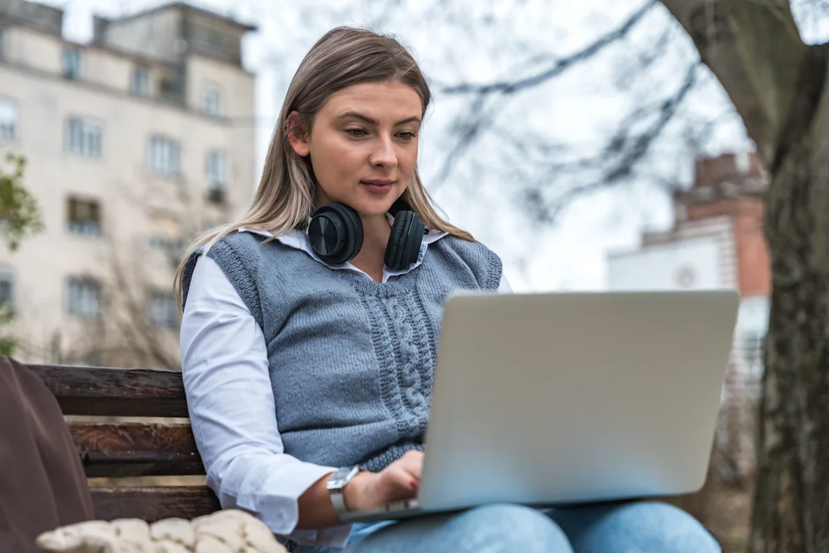 woman with headphones and on her laptop
