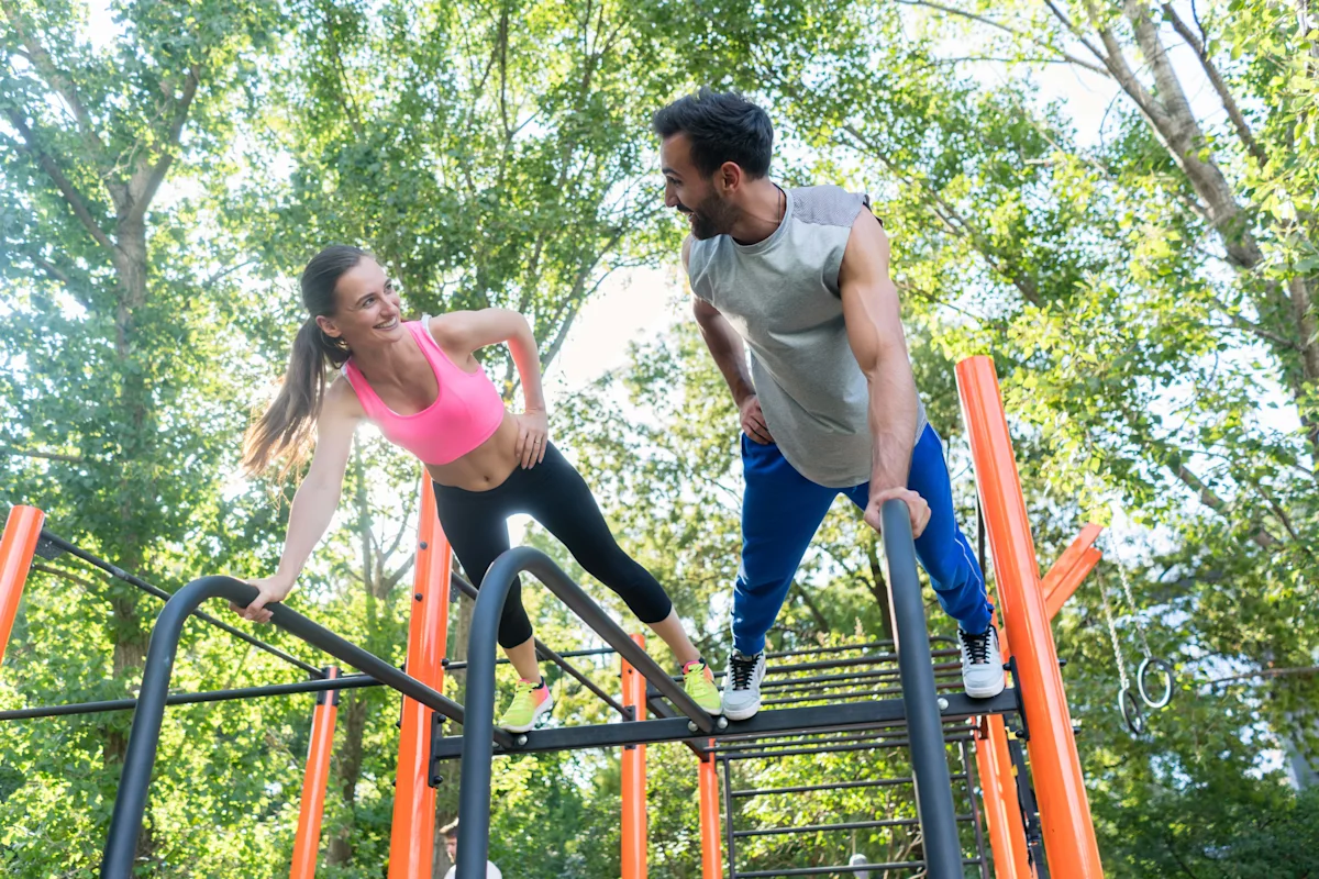 man and woman practicing calisthenics