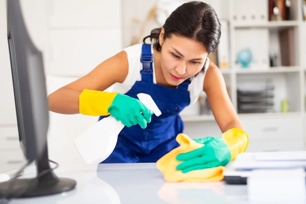 Woman cleaning a desk