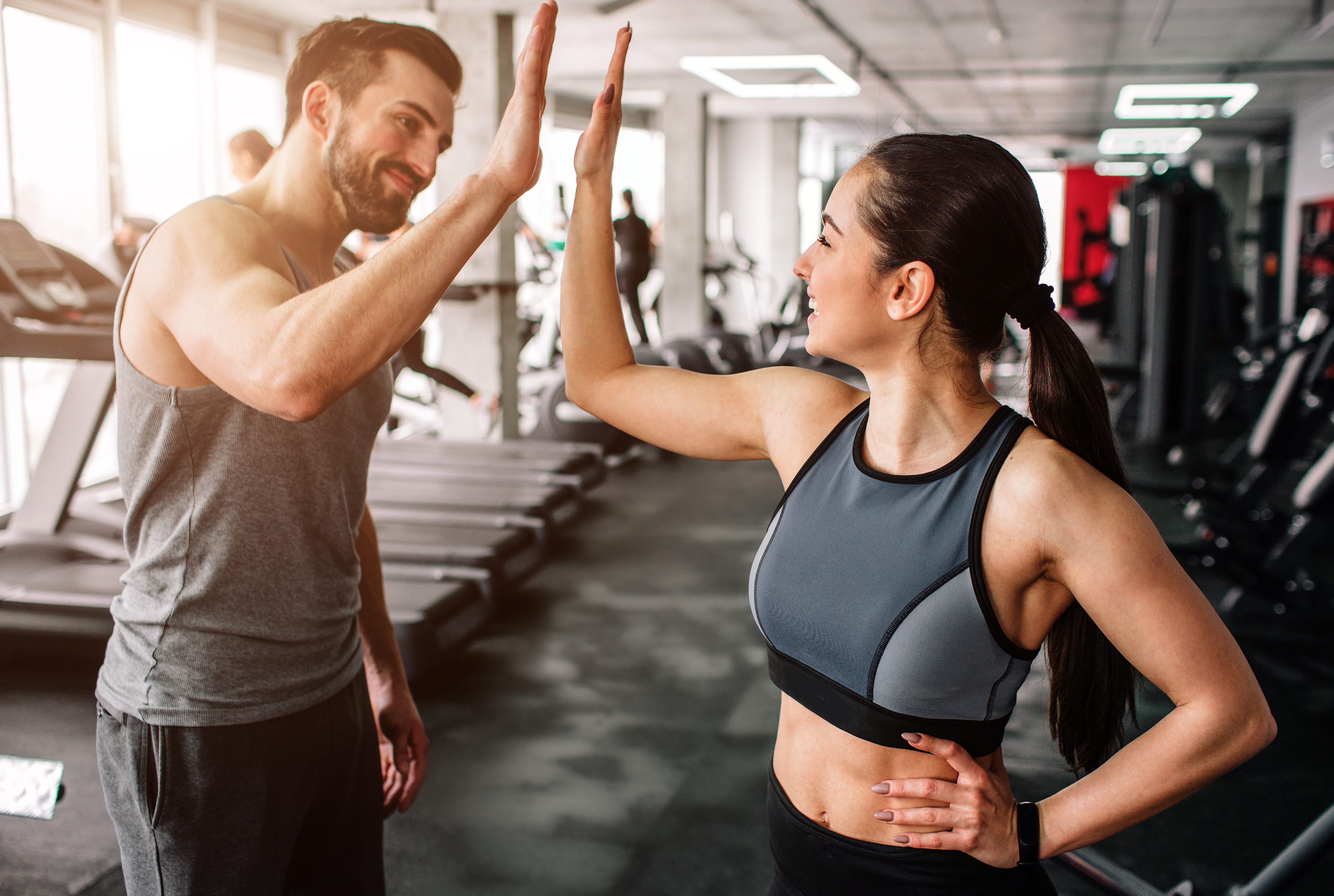 happy people at a gym going in for a high five