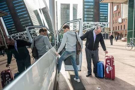 Man getting into airport taxi