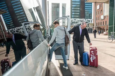 Man getting into airport taxi