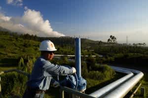 An engineer looking out over a section of the Indonesia Geothermal plant