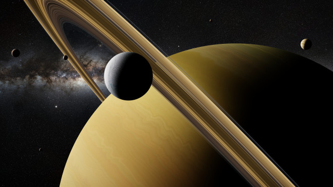 Saturn moon Enceladus in front of planet Saturn, rings and other moons