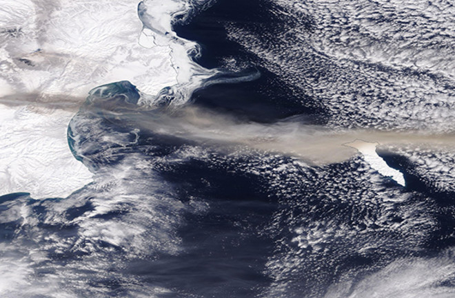 The long ash plume from Bezymianny seen stretching across the Pacific Ocean on March 17 by Terra's MODIS imager. The smaller plume from Sheveluch can be seen just above the darker Bezymianny plume. NASA.