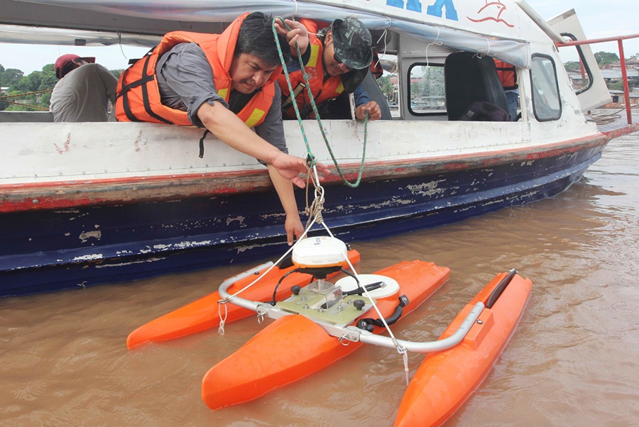 Researchers Releasing Buoy into River - Barbara Fraser