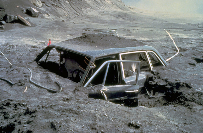 Car buried by ash and debris.