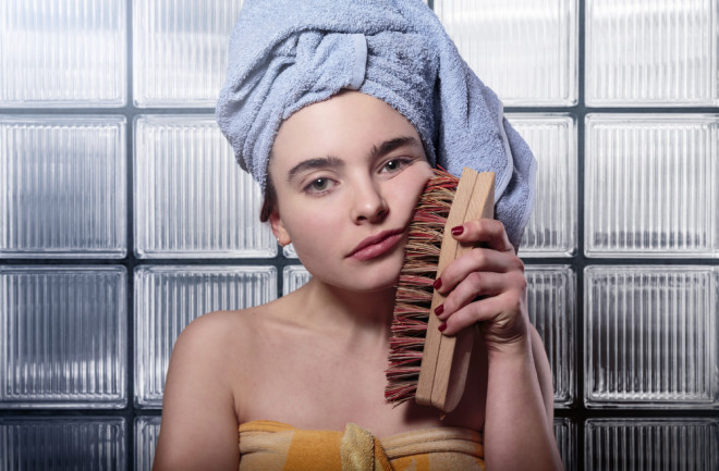 acne woman face brush shower - shutterstock