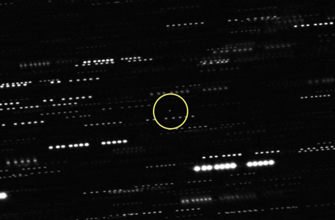 The best available image of 'Oumuamua shows just an enigmatic dot of light, circled in yellow; the dashed lines are stars that got smeared out as the telescope tracked the interstellar object. (Credit: ESO/K. Meech et al.)