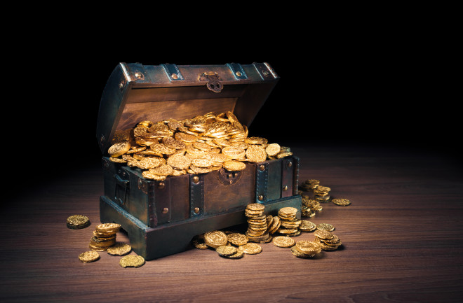 Open treasure chest filled with gold coins  