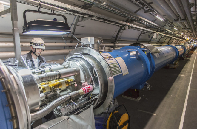 A technician works on the Large Hadron Collider at CERN. (Credit: CERN)
