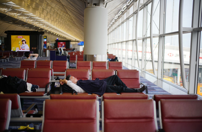Traveler sleeping in Hong Kong International Airport