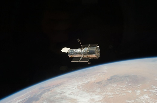 Hubble Space Telescope floates above Earth