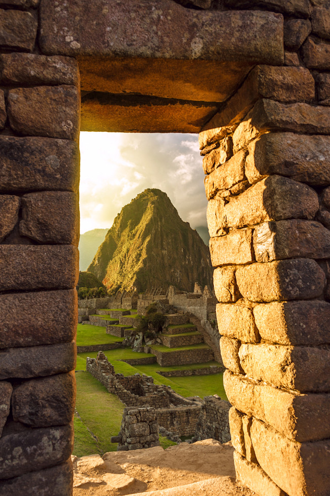 inca doorway framing a mountain - shutterstock