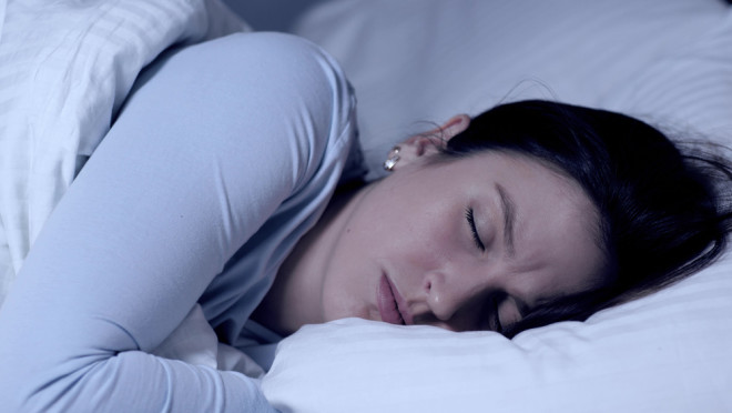 Woman frowning while having a bad dream