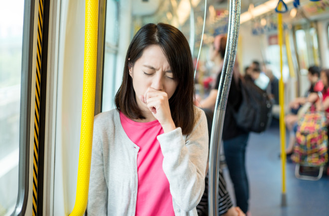 person coughing on public transit