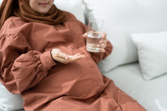 pregnant person with supplement