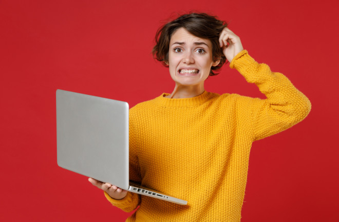 woman worried computer - shutterstock