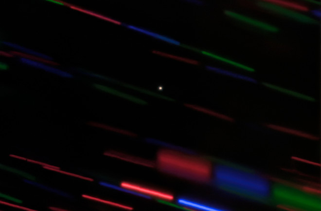 Earth's new minimoon, catalogued as 2020 CD3, shows up as a dot in this image from the Gemini Observatory. Tracking the object as it moved turned surrounding stars into colored streaks. (Credit: Gemini/OIR/AURA/G. Fedorets)