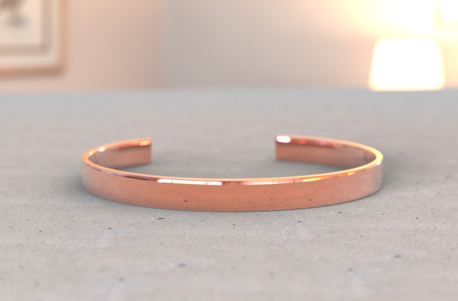 Copper bracelet pain on a table - shutterstock
