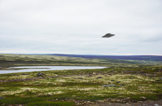 UFO floating above tundra landscape
