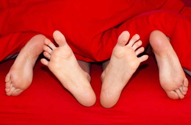 Feet in bed sex - Shutterstock