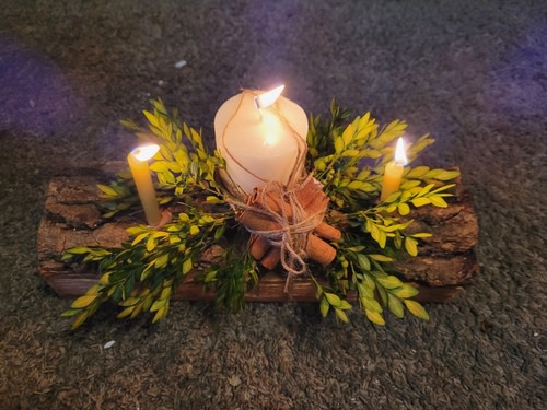 yuel log with greenery and candle