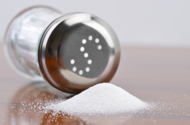 Salt spilling on table from salt cellar