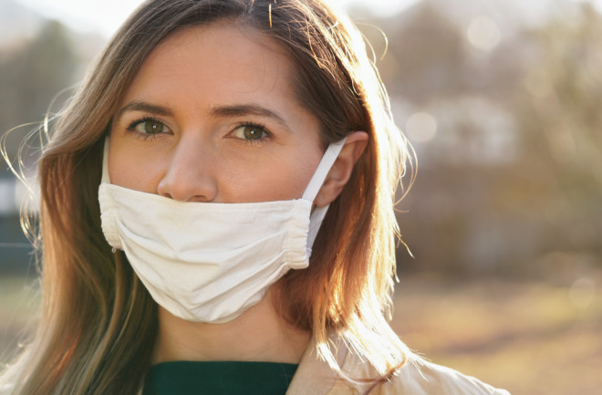 woman wearing mask improperly with nose exposed - shutterstock