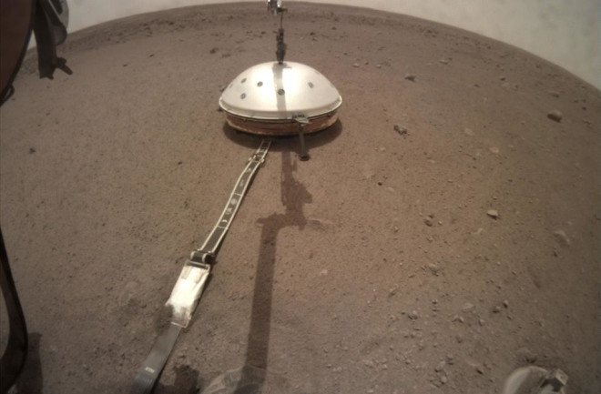 a small dome held by InSight's robotic arm on Mars