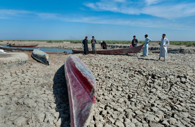  Boats on dried cracked earth of the Euphrates River. Euphrates river drying up