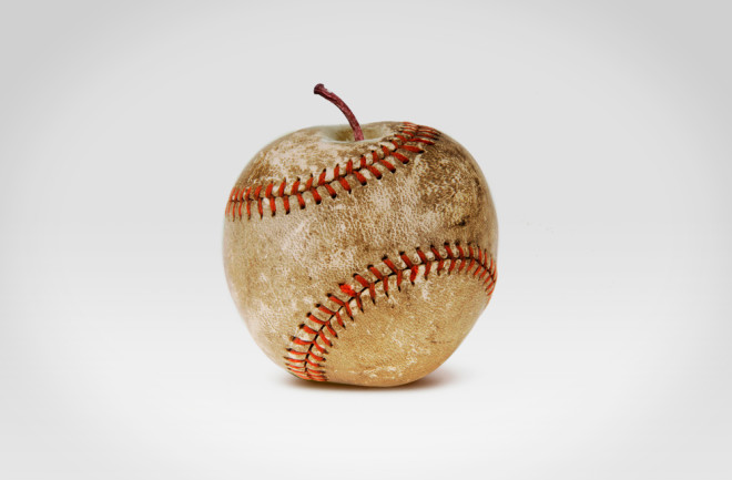 An old shabby baseball with red stitches in the form of an apple isolated on white background - shutterstock 1008879742