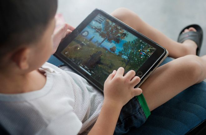 Kid playing on tablet