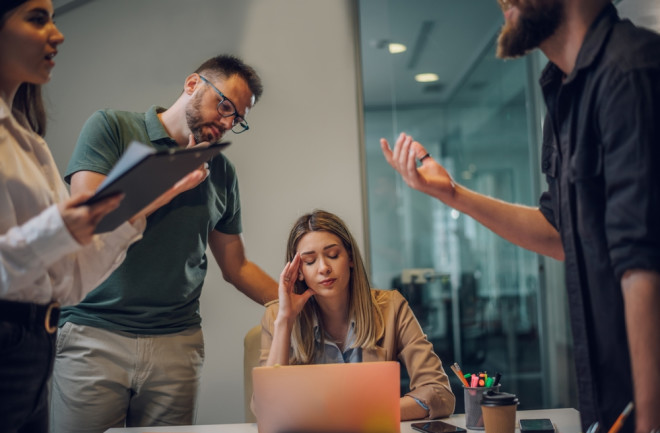 stressful-work-environment-four-coworkers-around-computer