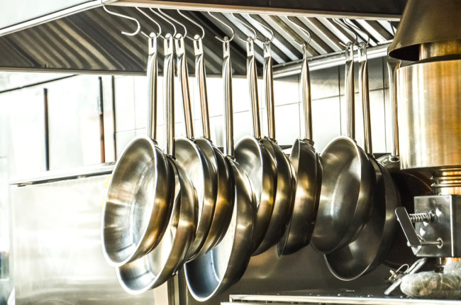 stainless steel pans hanging - shutterstock